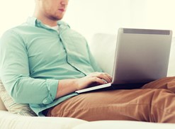 Man types on his laptop