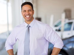 Sales associate smiles after a hard days work