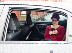Young professional hides from her boss in her car