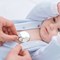 A pediatrician monitors a babys heartbeat